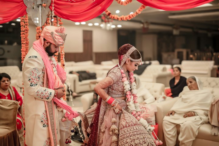 A bride and groom in traditional Indian wedding attire at their ceremony