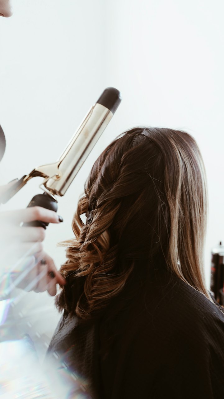 Long hair being curled with a curling tong